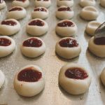 thumbprint cookies being filled with jam